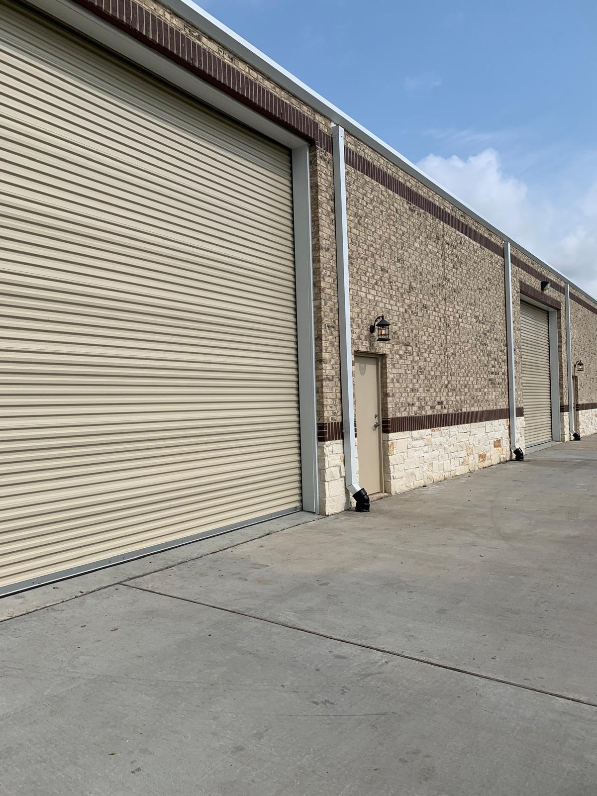 Warehouse exterior painting with roll-up doors Houston TX