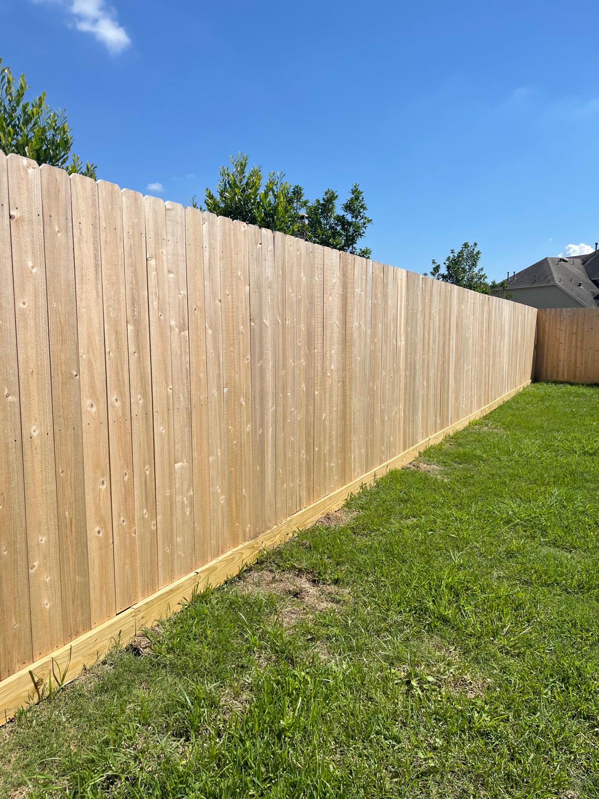 Natural unstained wood privacy fence